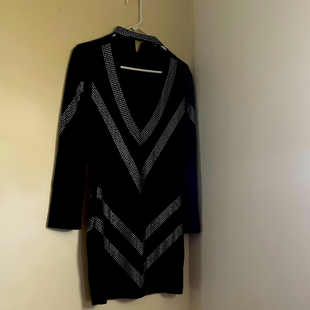 Black dress with rhinestone design a lot of cleavage showing and dress short